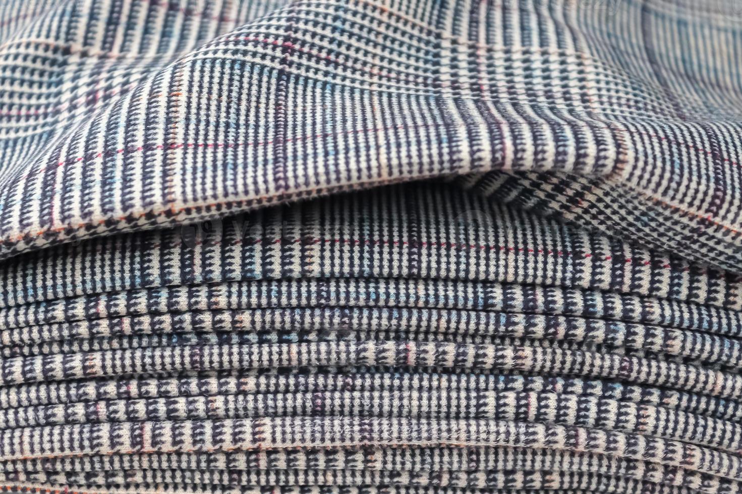Detailed close up view on samples of cloth and fabrics in different colors found at a fabrics market photo