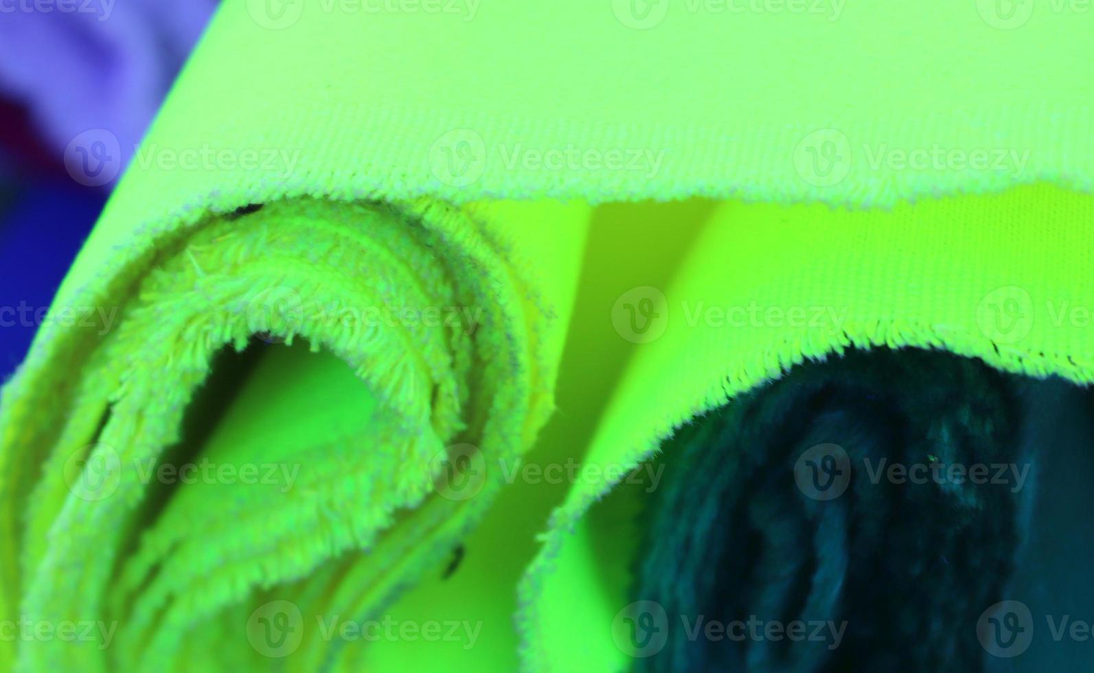 Detailed close up view on samples of cloth and fabrics in different colors found at a fabrics market photo