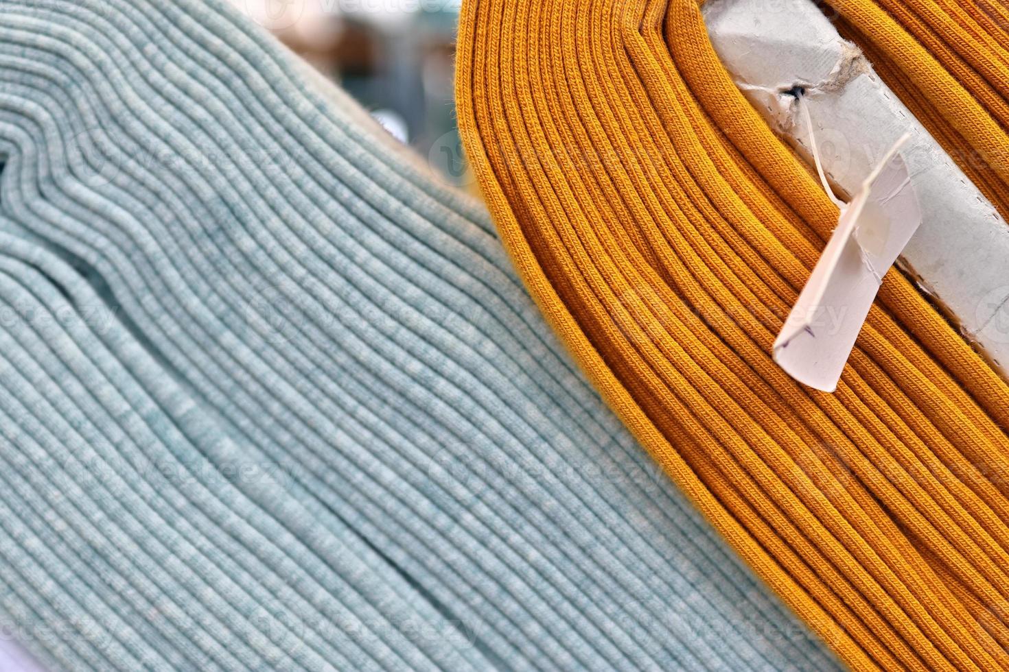 Detailed close up view on samples of cloth and fabrics in different colors found at a fabrics market photo