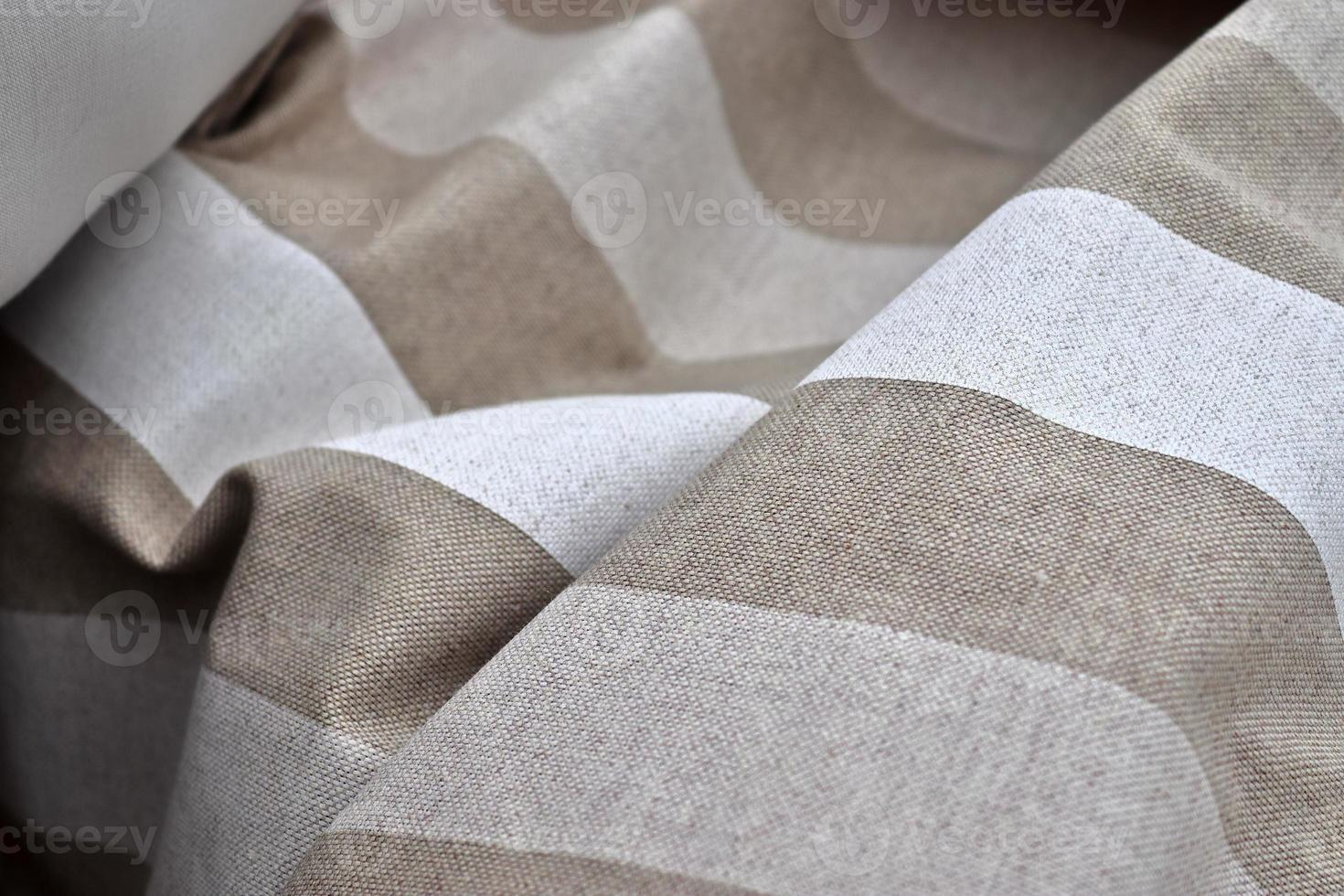Detailed close up view on samples of cloth and fabrics in different colors found at a fabrics market photo