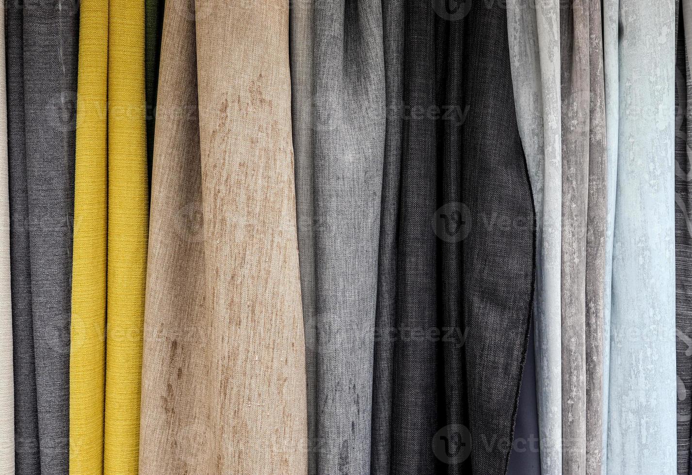 Detailed close up view on samples of cloth and fabrics in different colors found at a fabrics market photo