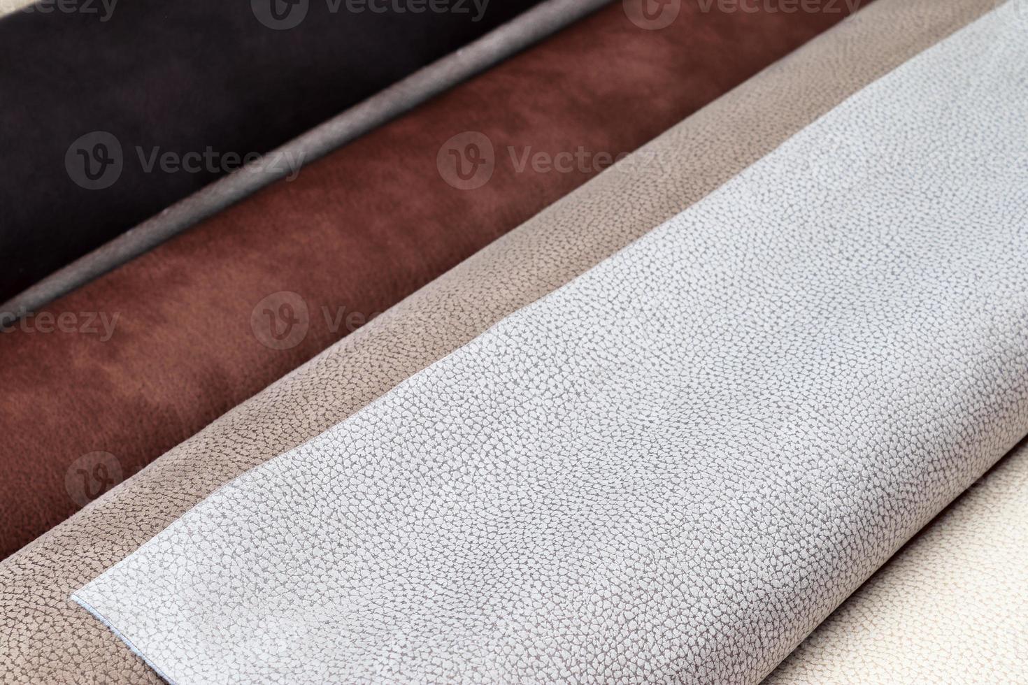 Detailed close up view on samples of cloth and fabrics in different colors found at a fabrics market photo