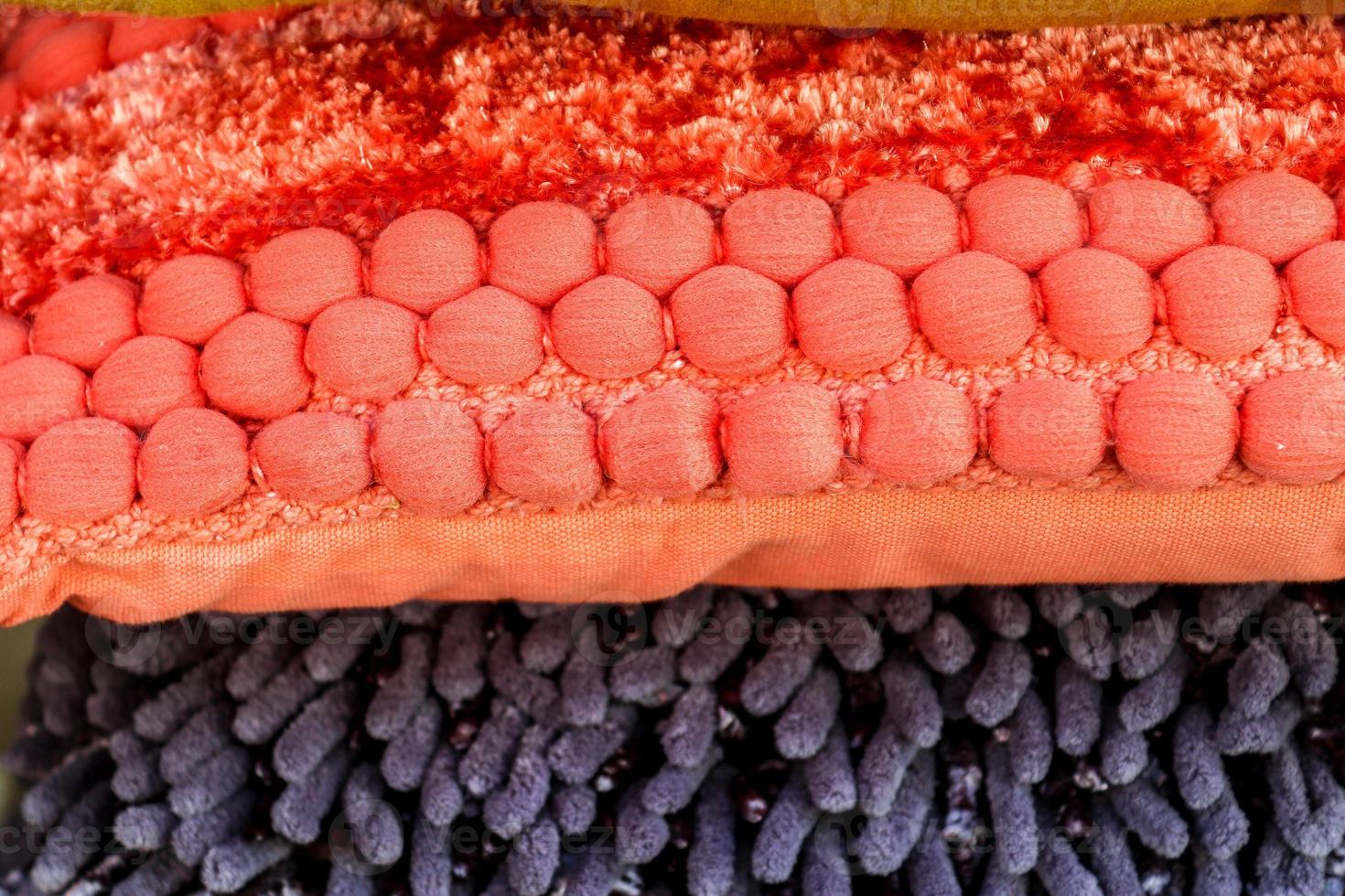 Detailed close up view on samples of cloth and fabrics in different colors found at a fabrics market photo