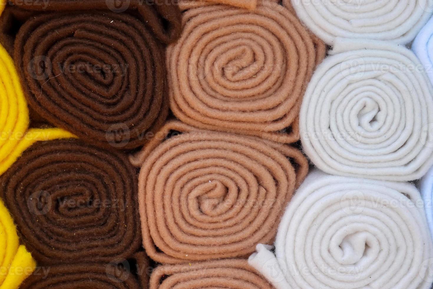 Detailed close up view on samples of cloth and fabrics in different colors found at a fabrics market photo