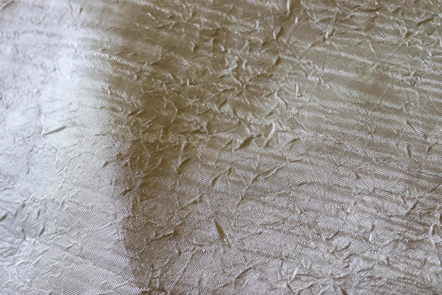 Detailed close up view on samples of cloth and fabrics in different colors found at a fabrics market photo