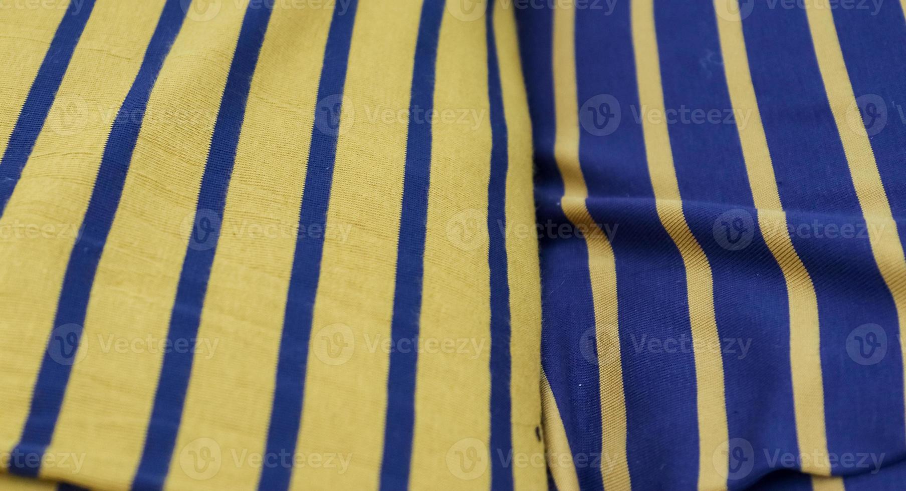 Detailed close up view on samples of cloth and fabrics in different colors found at a fabrics market photo