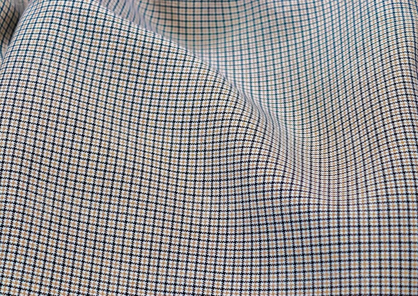 Detailed close up view on samples of cloth and fabrics in different colors found at a fabrics market photo