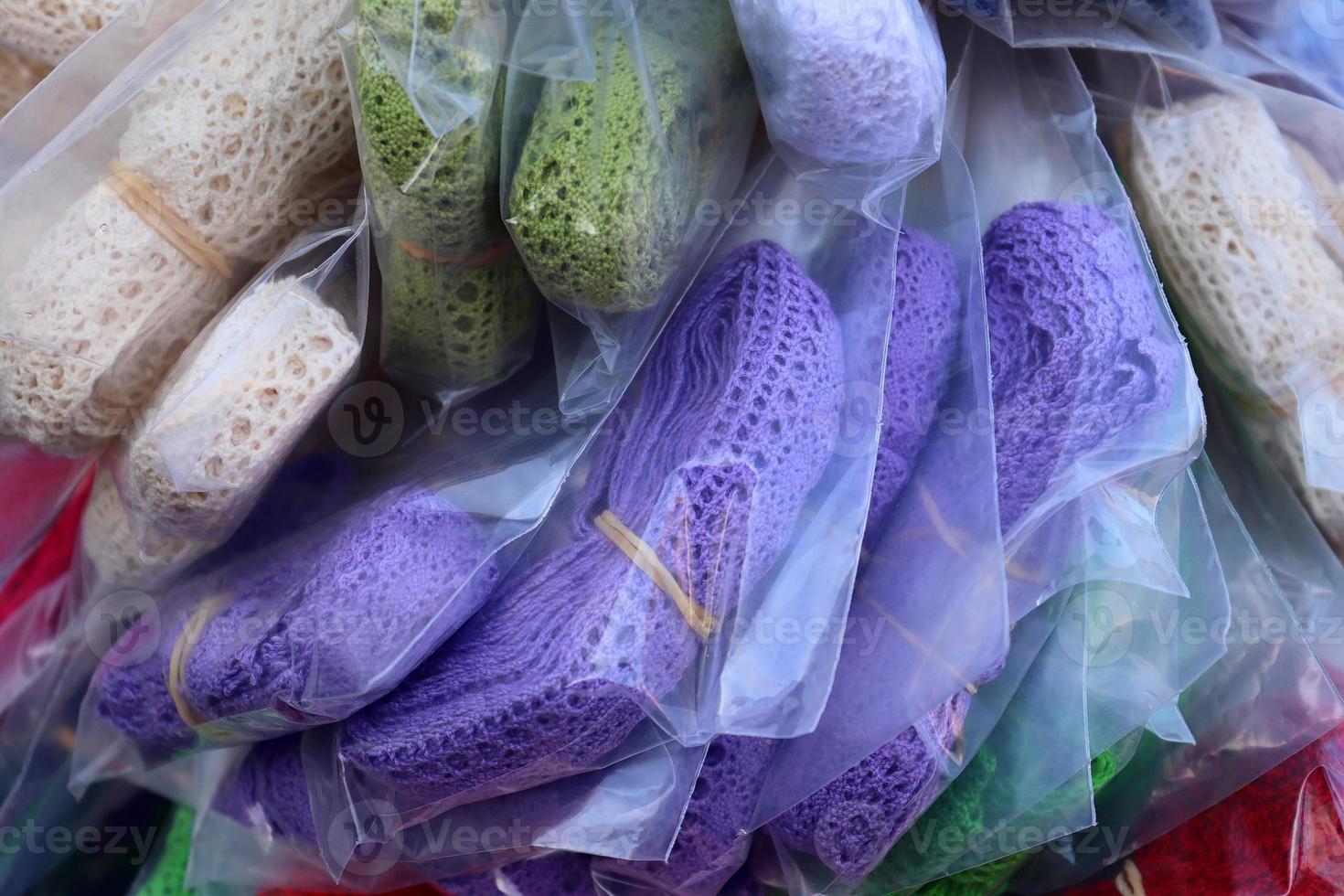 Detailed close up view on samples of cloth and fabrics in different colors found at a fabrics market photo