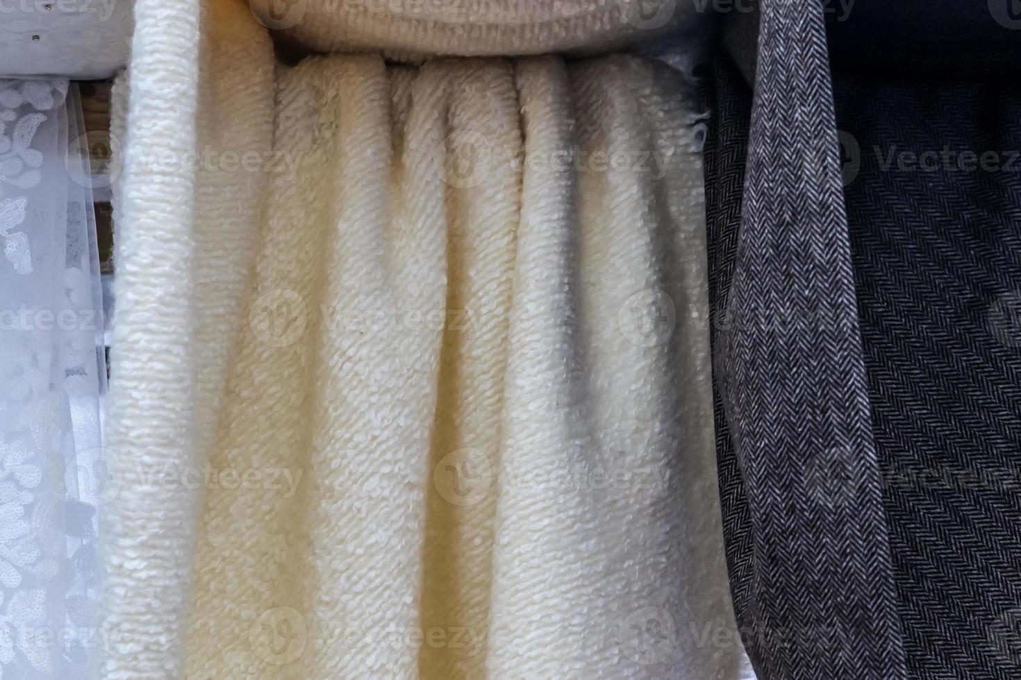 Detailed close up view on samples of cloth and fabrics in different colors found at a fabrics market photo
