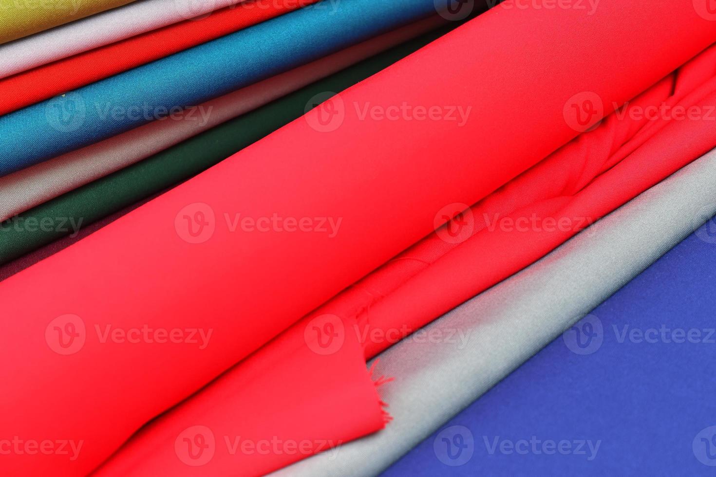 Detailed close up view on samples of cloth and fabrics in different colors found at a fabrics market photo