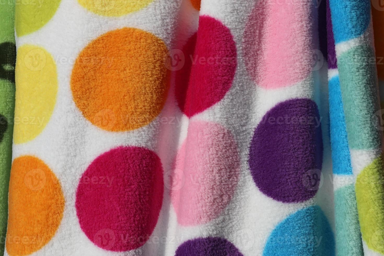 Detailed close up view on samples of cloth and fabrics in different colors found at a fabrics market photo