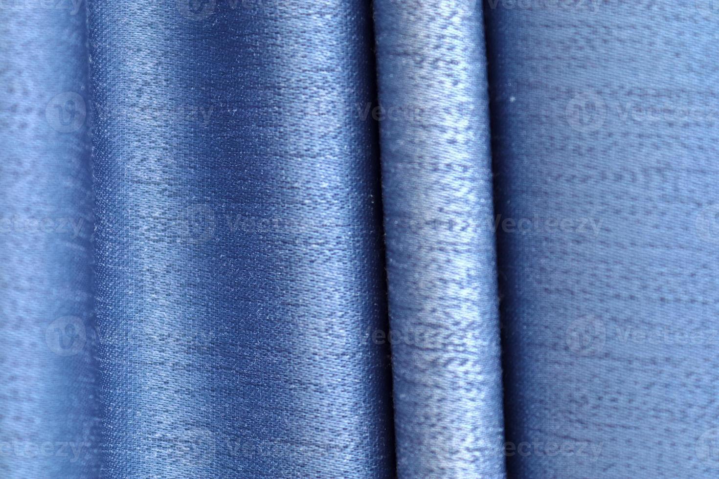 Detailed close up view on samples of cloth and fabrics in different colors found at a fabrics market photo
