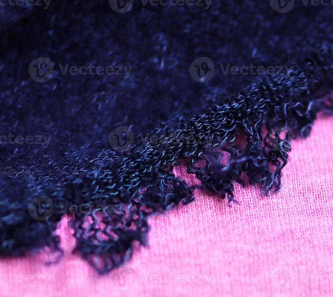 Detailed close up view on samples of cloth and fabrics in different colors found at a fabrics market photo