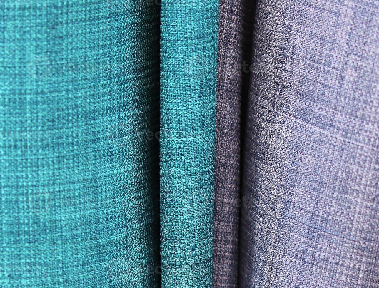 Detailed close up view on samples of cloth and fabrics in different colors found at a fabrics market photo