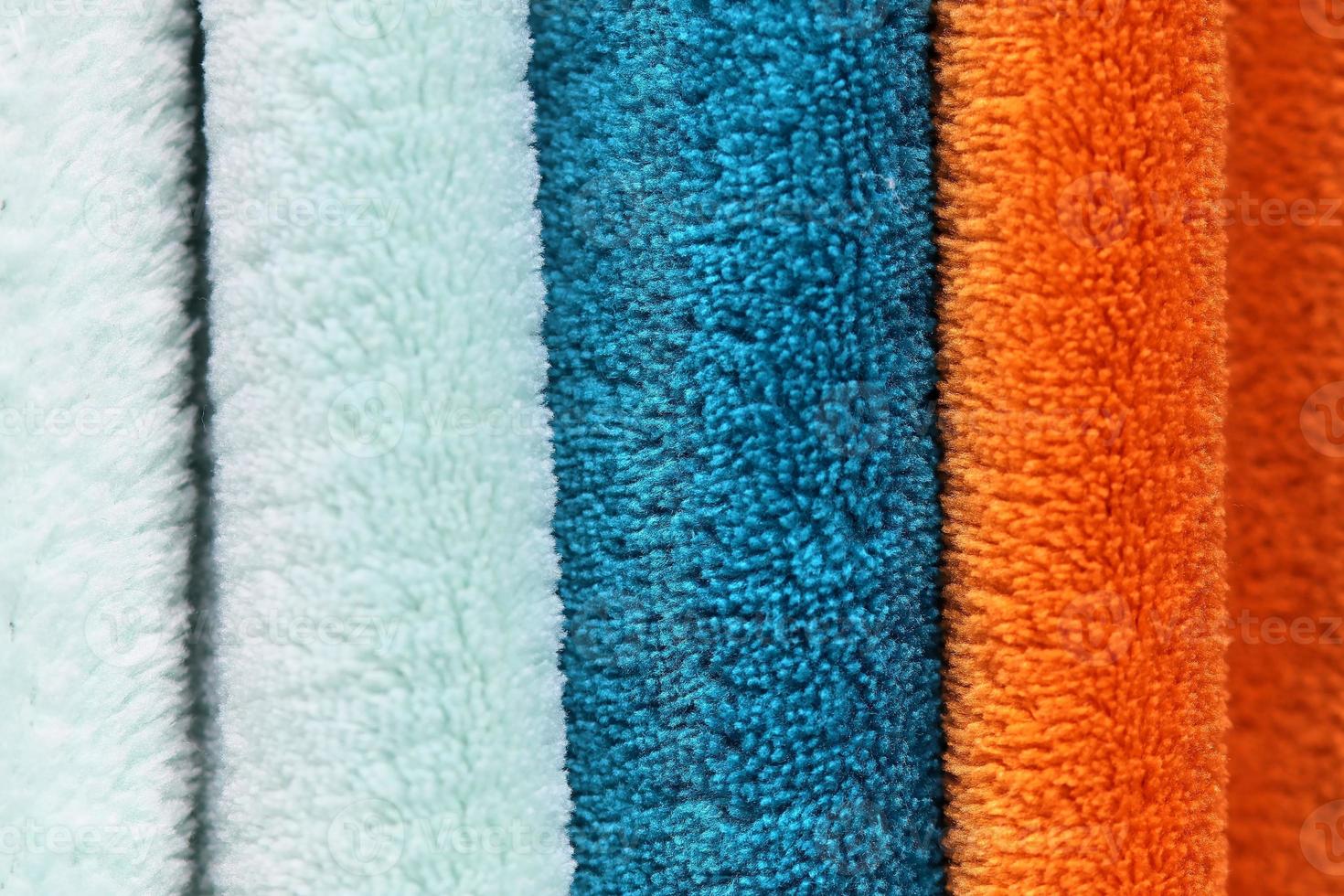 Detailed close up view on samples of cloth and fabrics in different colors found at a fabrics market photo