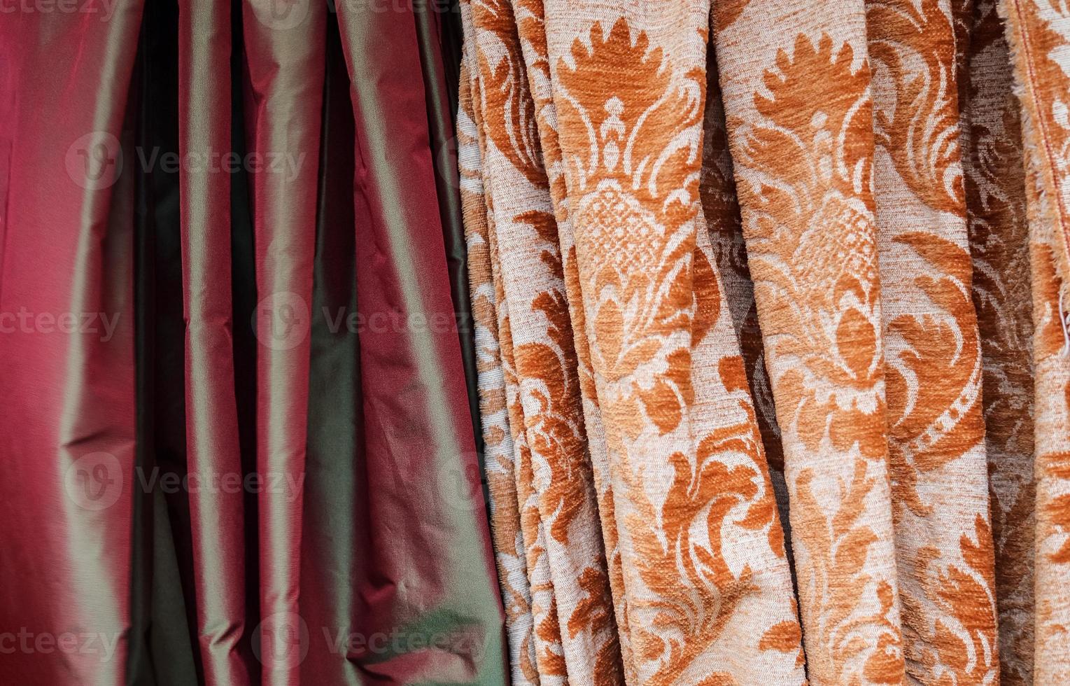 Detailed close up view on samples of cloth and fabrics in different colors found at a fabrics market photo