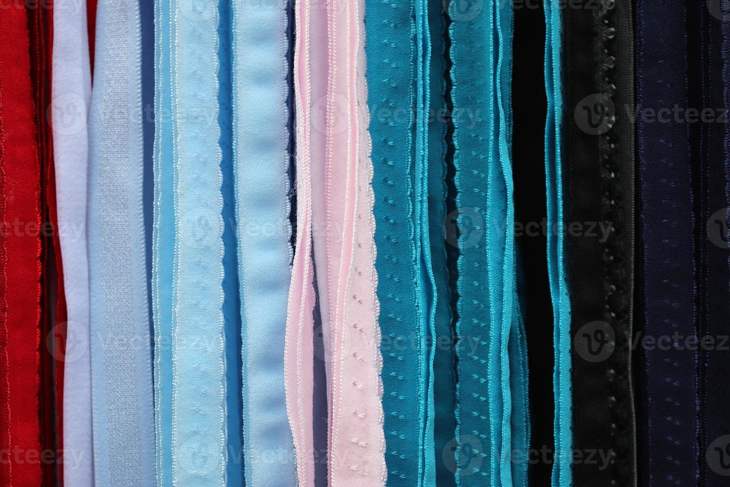 Detailed close up view on samples of cloth and fabrics in different colors found at a fabrics market photo