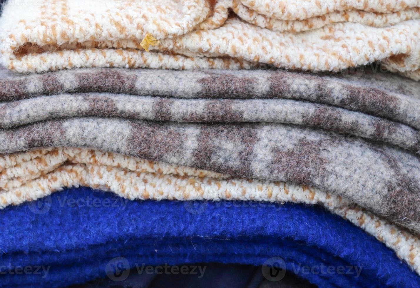 Detailed close up view on samples of cloth and fabrics in different colors found at a fabrics market photo