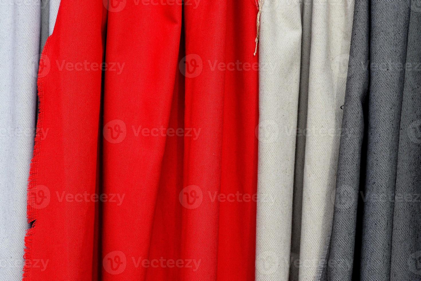 Detailed close up view on samples of cloth and fabrics in different colors found at a fabrics market photo