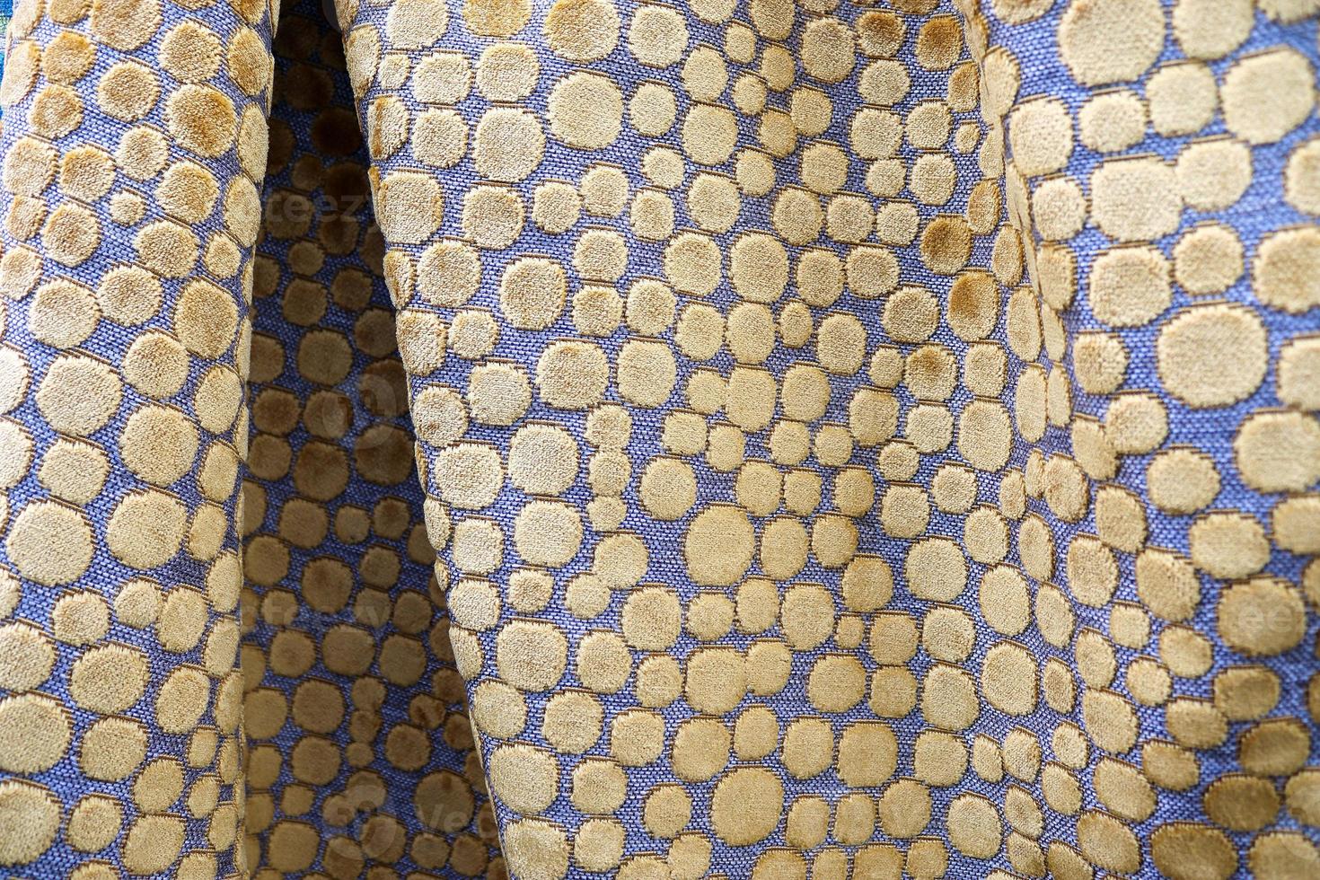 Detailed close up view on samples of cloth and fabrics in different colors found at a fabrics market photo