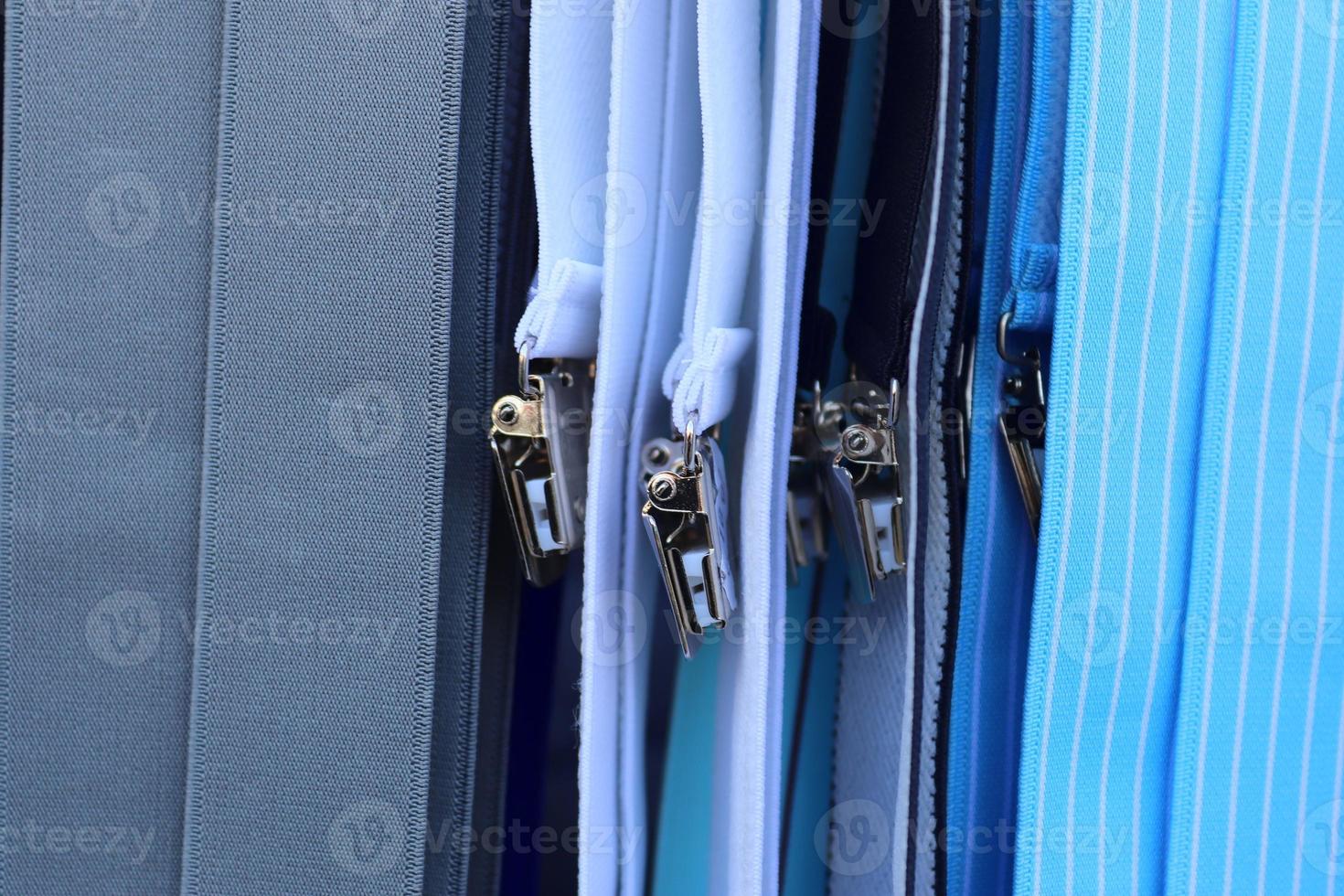 Detailed close up view on samples of cloth and fabrics in different colors found at a fabrics market photo