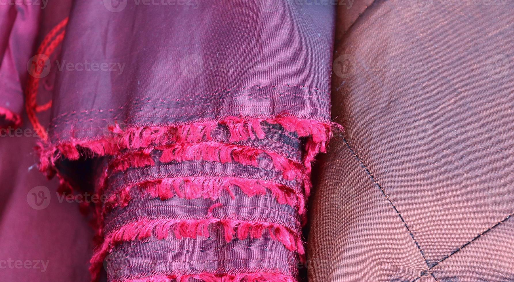 Detailed close up view on samples of cloth and fabrics in different colors found at a fabrics market photo