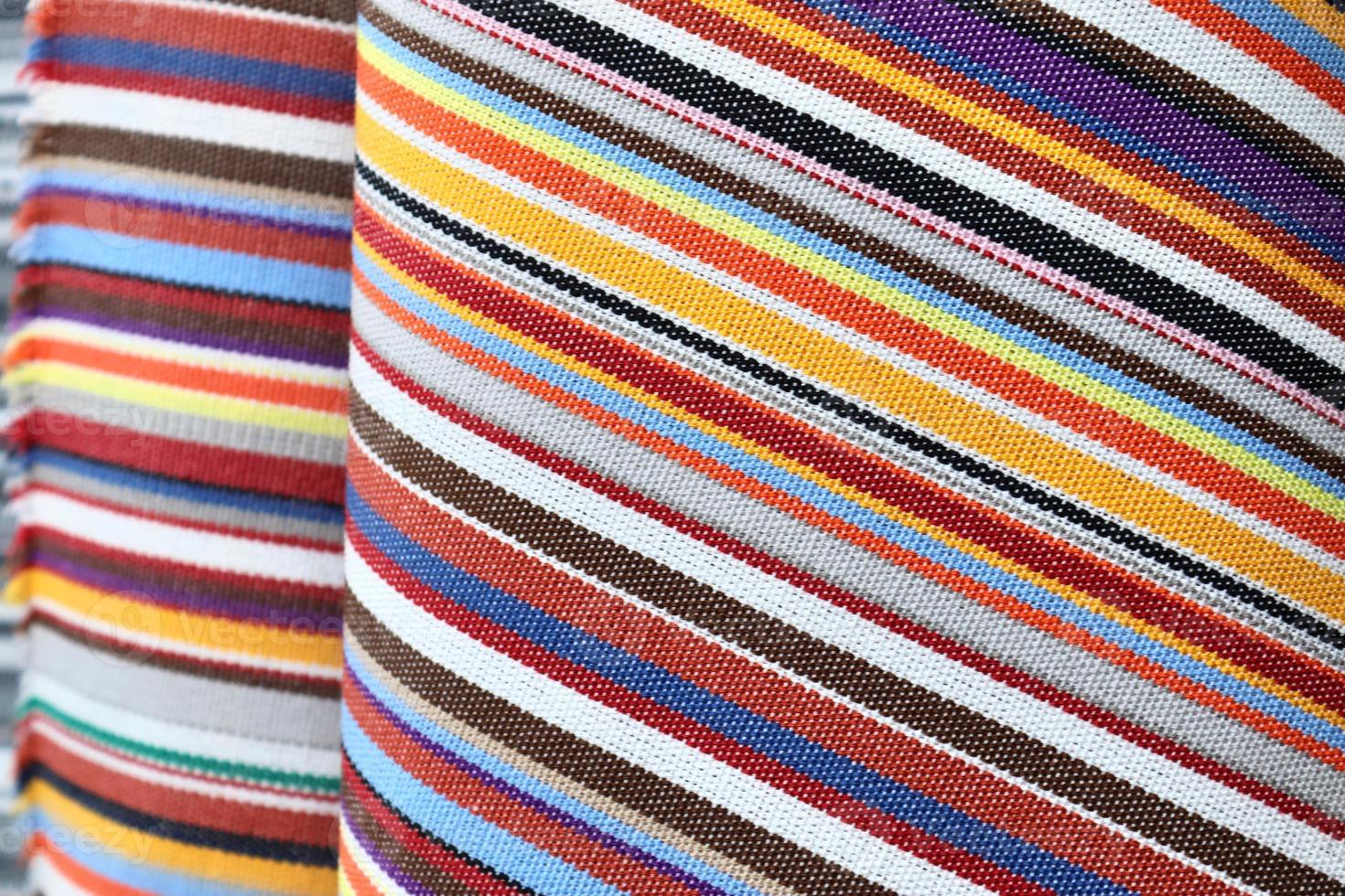 Detailed close up view on samples of cloth and fabrics in different colors found at a fabrics market photo