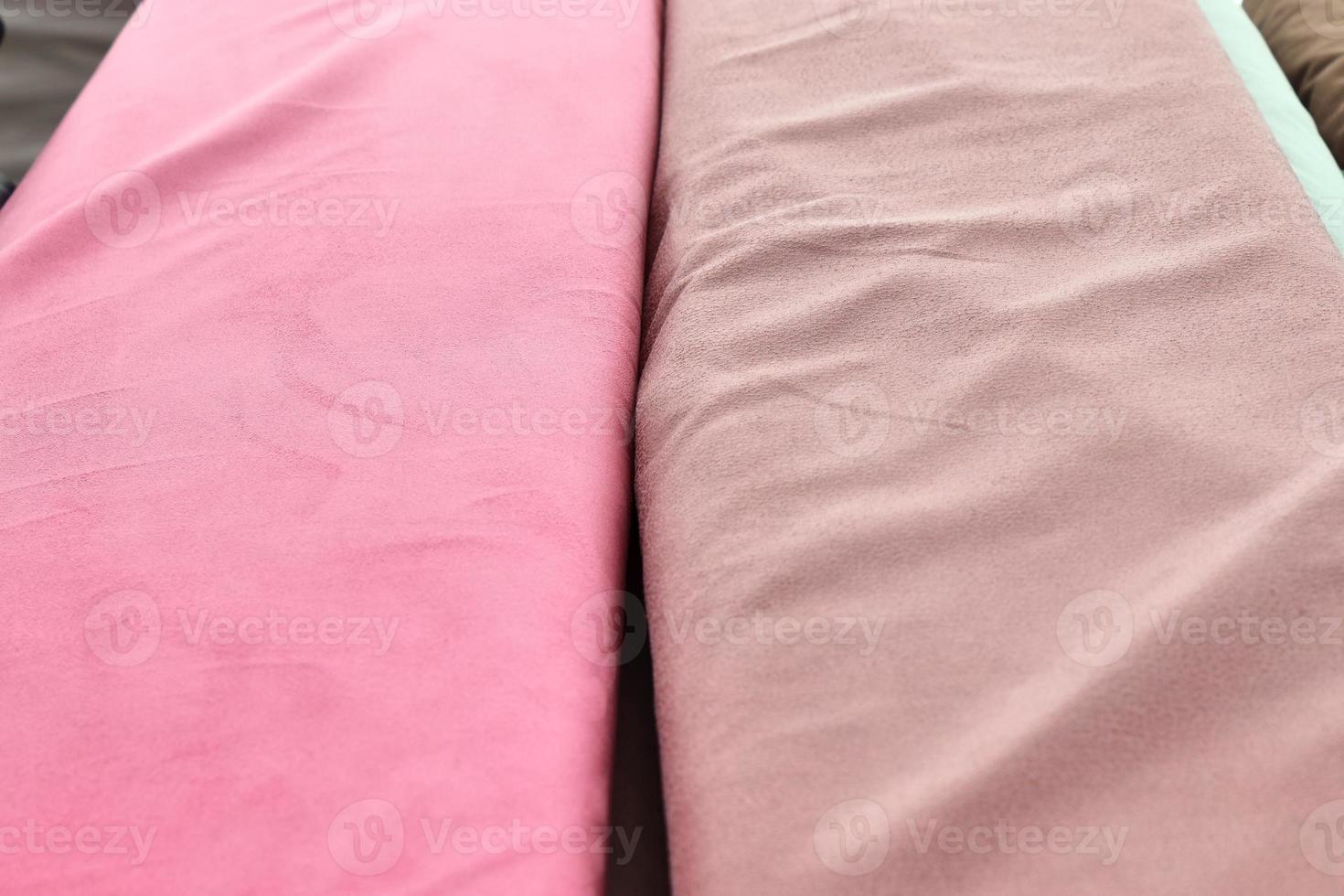 Detailed close up view on samples of cloth and fabrics in different colors found at a fabrics market photo