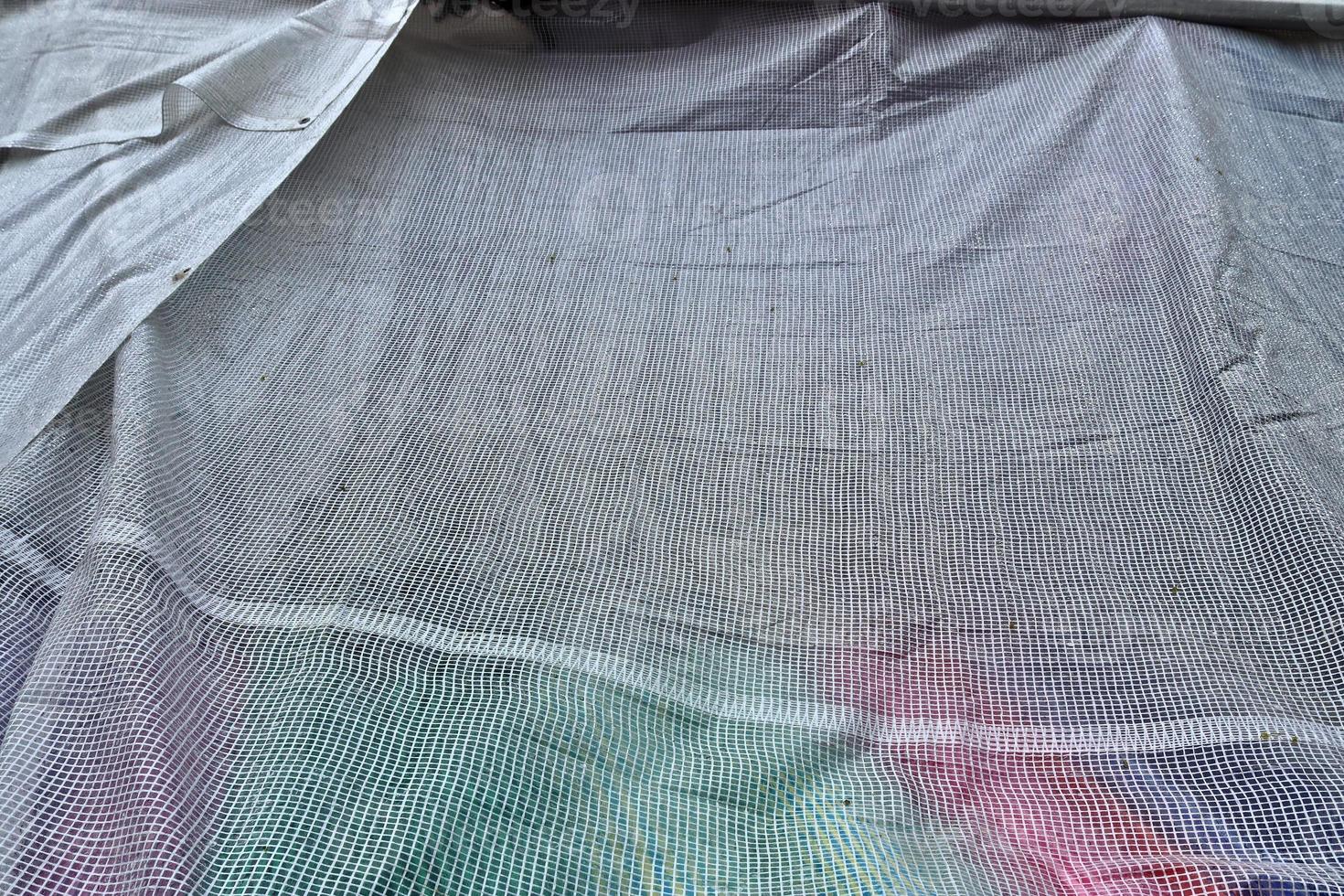 Detailed close up view on samples of cloth and fabrics in different colors found at a fabrics market photo