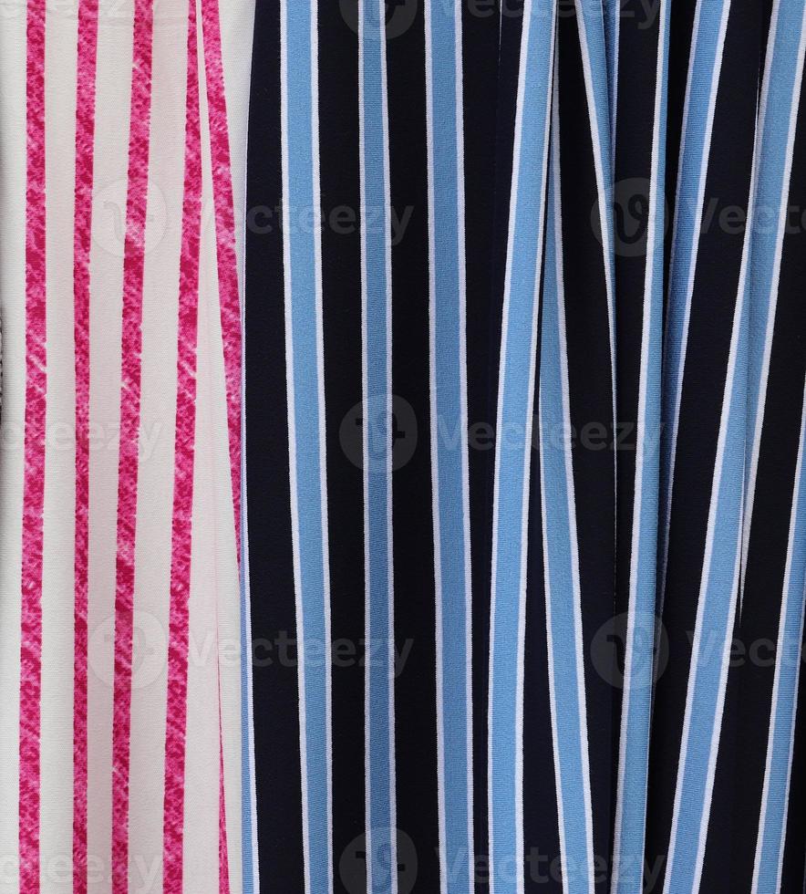 Detailed close up view on samples of cloth and fabrics in different colors found at a fabrics market photo