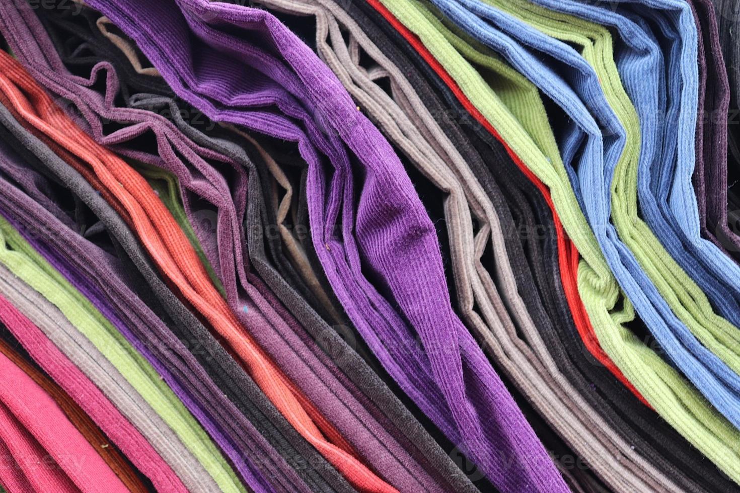 Detailed close up view on samples of cloth and fabrics in different colors found at a fabrics market photo