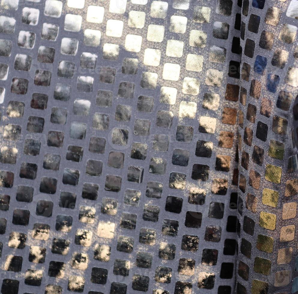 Detailed close up view on samples of cloth and fabrics in different colors found at a fabrics market photo