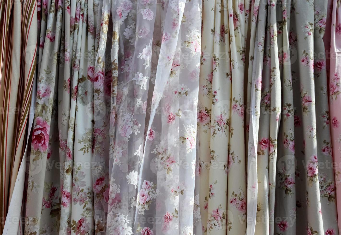 Detailed close up view on samples of cloth and fabrics in different colors found at a fabrics market photo