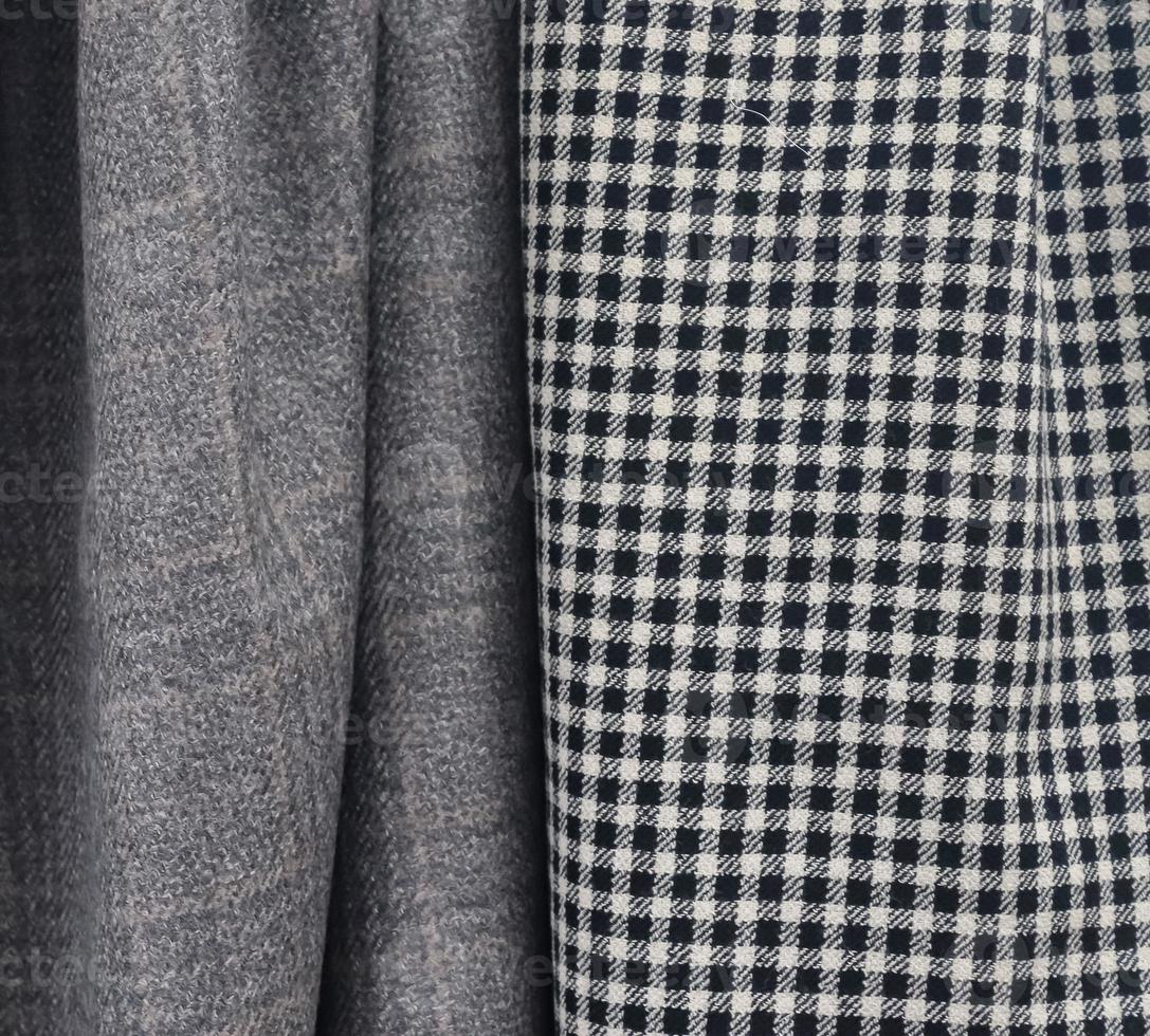 Detailed close up view on samples of cloth and fabrics in different colors found at a fabrics market photo