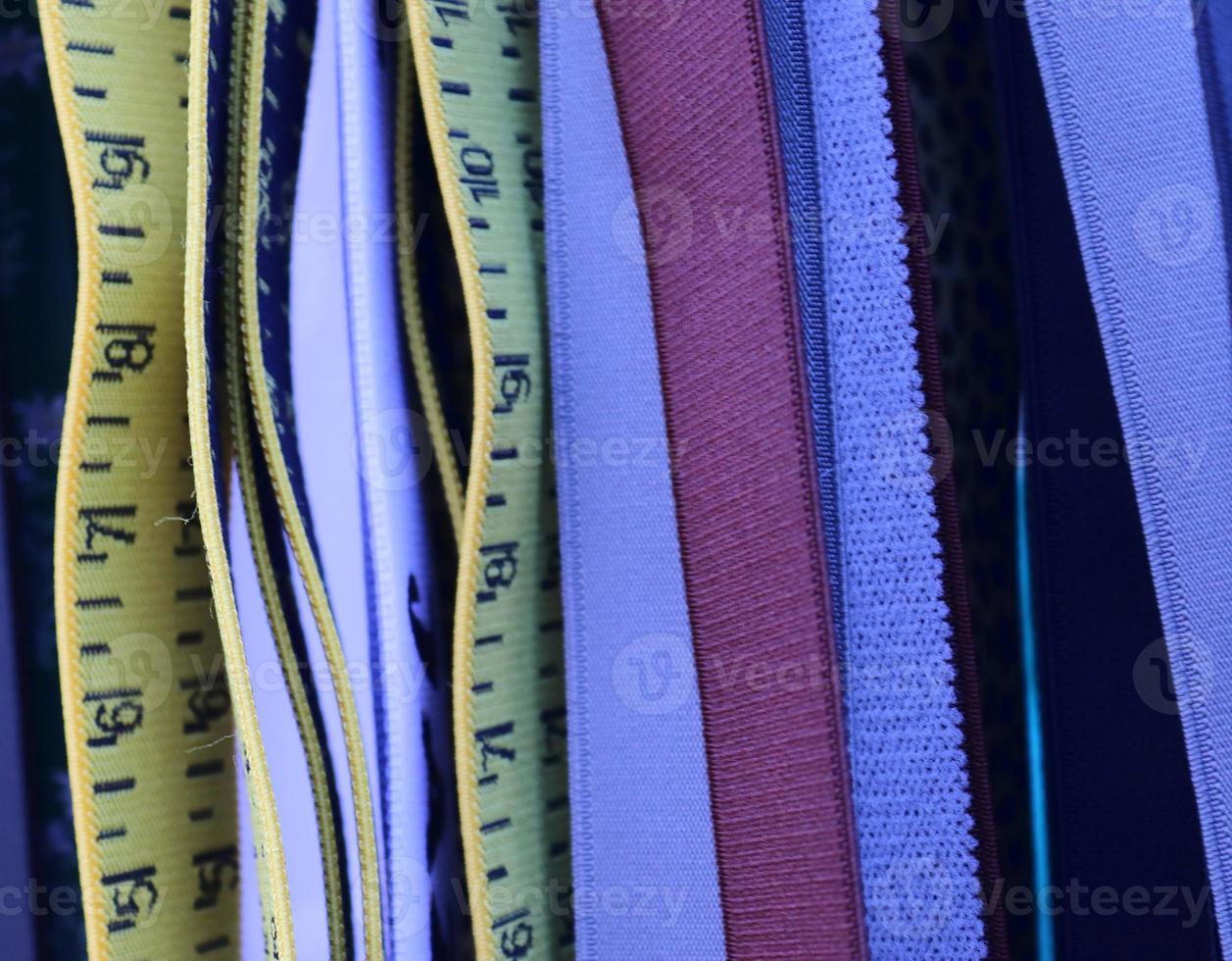 Detailed close up view on samples of cloth and fabrics in different colors found at a fabrics market photo
