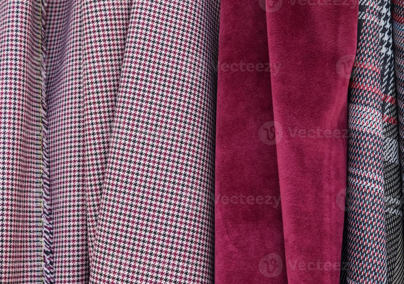 Detailed close up view on samples of cloth and fabrics in different colors found at a fabrics market photo