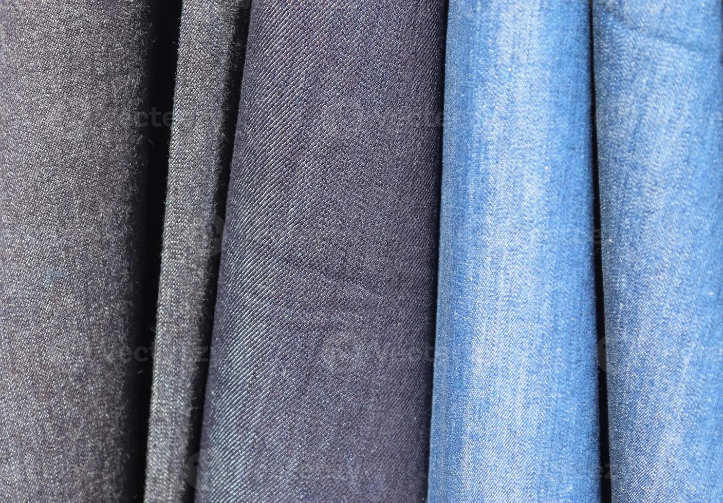 Detailed close up view on samples of cloth and fabrics in different colors found at a fabrics market photo
