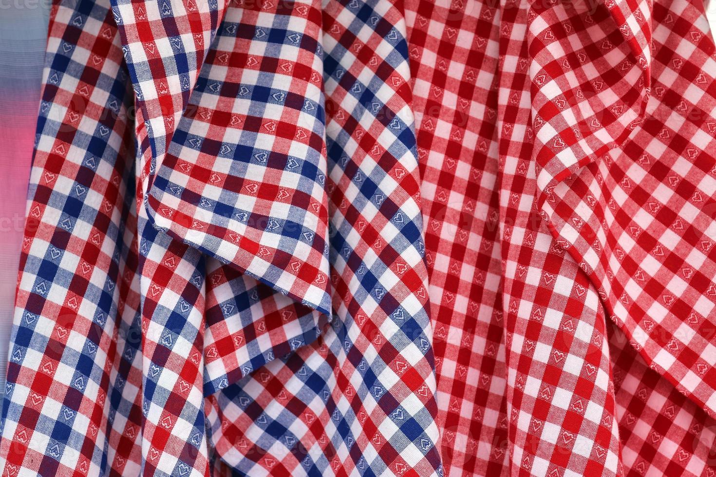 Detailed close up view on samples of cloth and fabrics in different colors found at a fabrics market photo