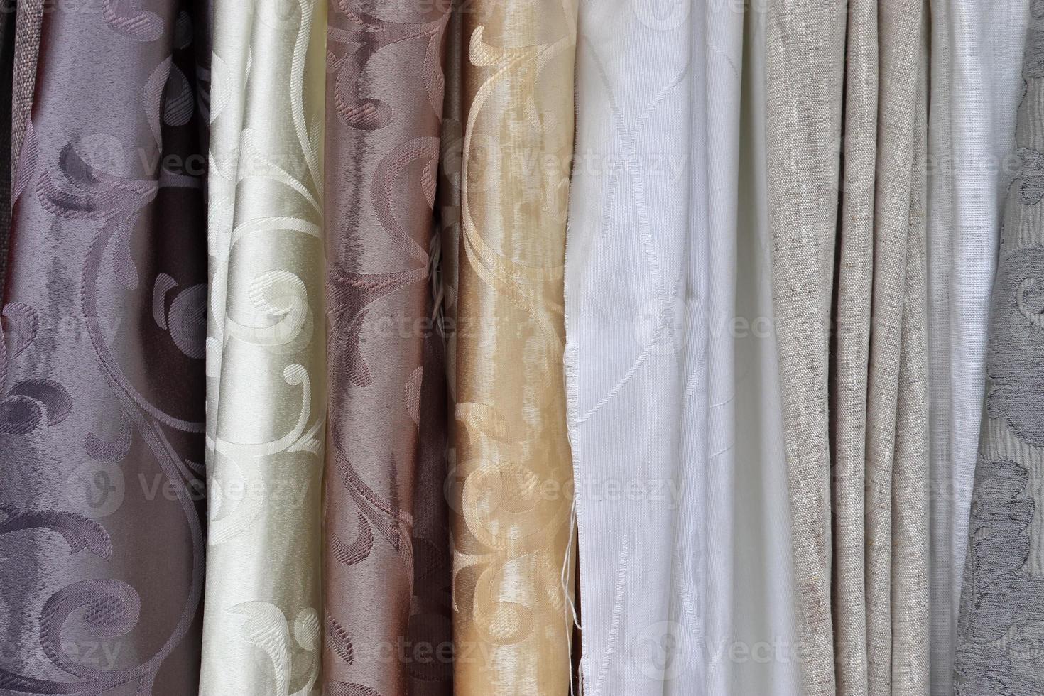 Detailed close up view on samples of cloth and fabrics in different colors found at a fabrics market photo