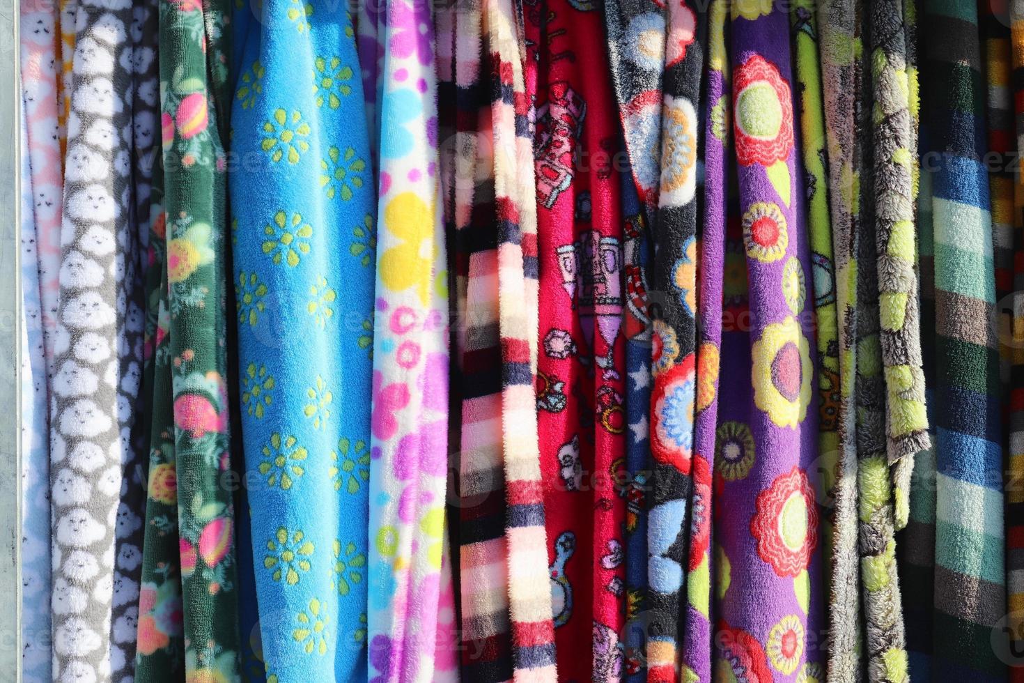Detailed close up view on samples of cloth and fabrics in different colors found at a fabrics market photo