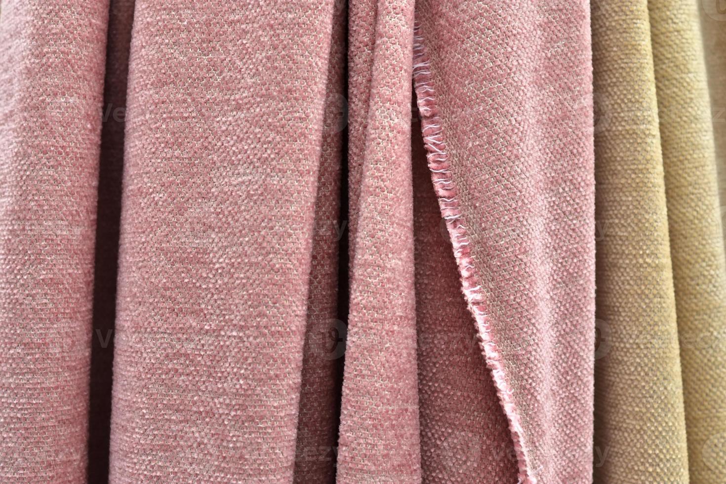 Detailed close up view on samples of cloth and fabrics in different colors found at a fabrics market photo