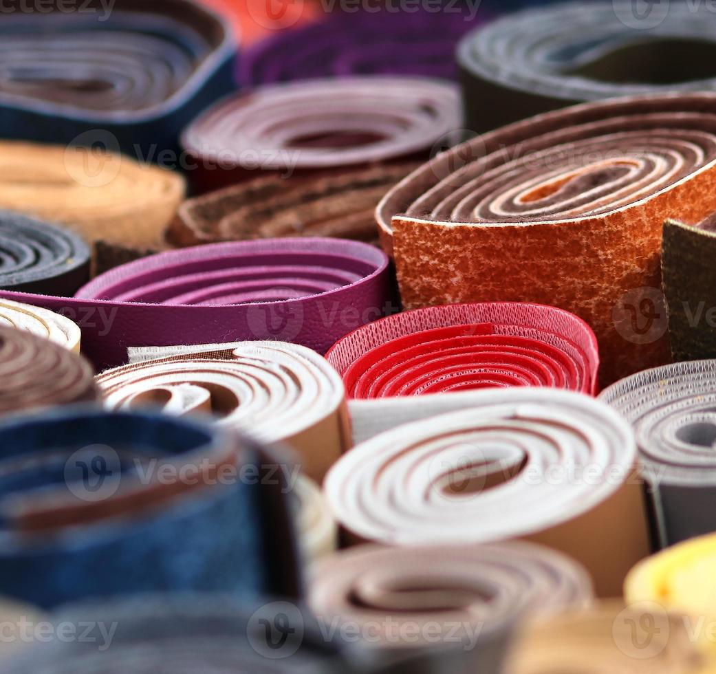 Detailed close up view on samples of cloth and fabrics in different colors found at a fabrics market photo
