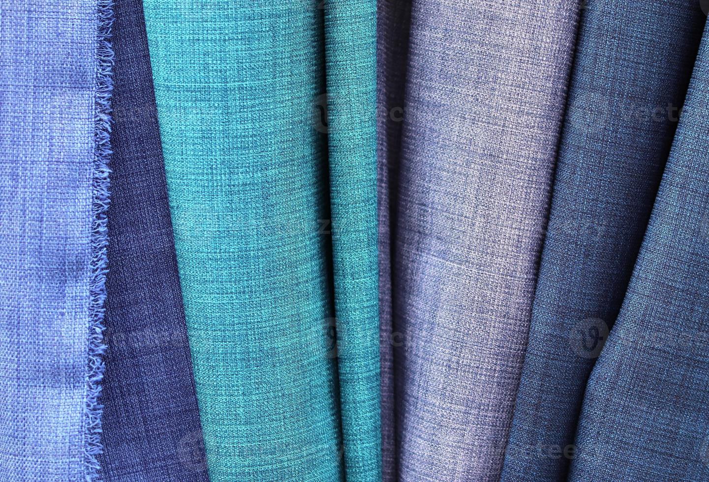 Detailed close up view on samples of cloth and fabrics in different colors found at a fabrics market photo