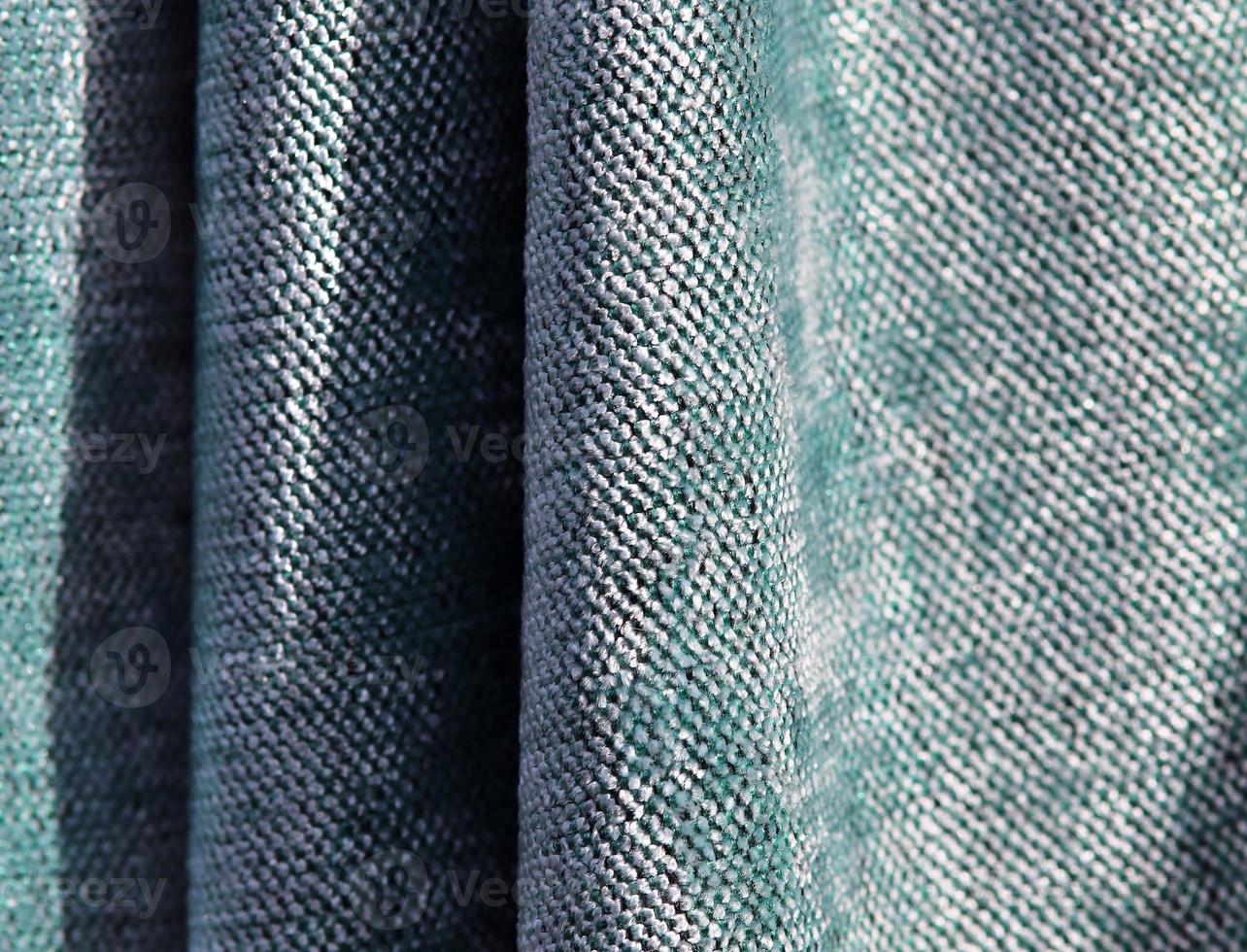 Detailed close up view on samples of cloth and fabrics in different colors found at a fabrics market photo