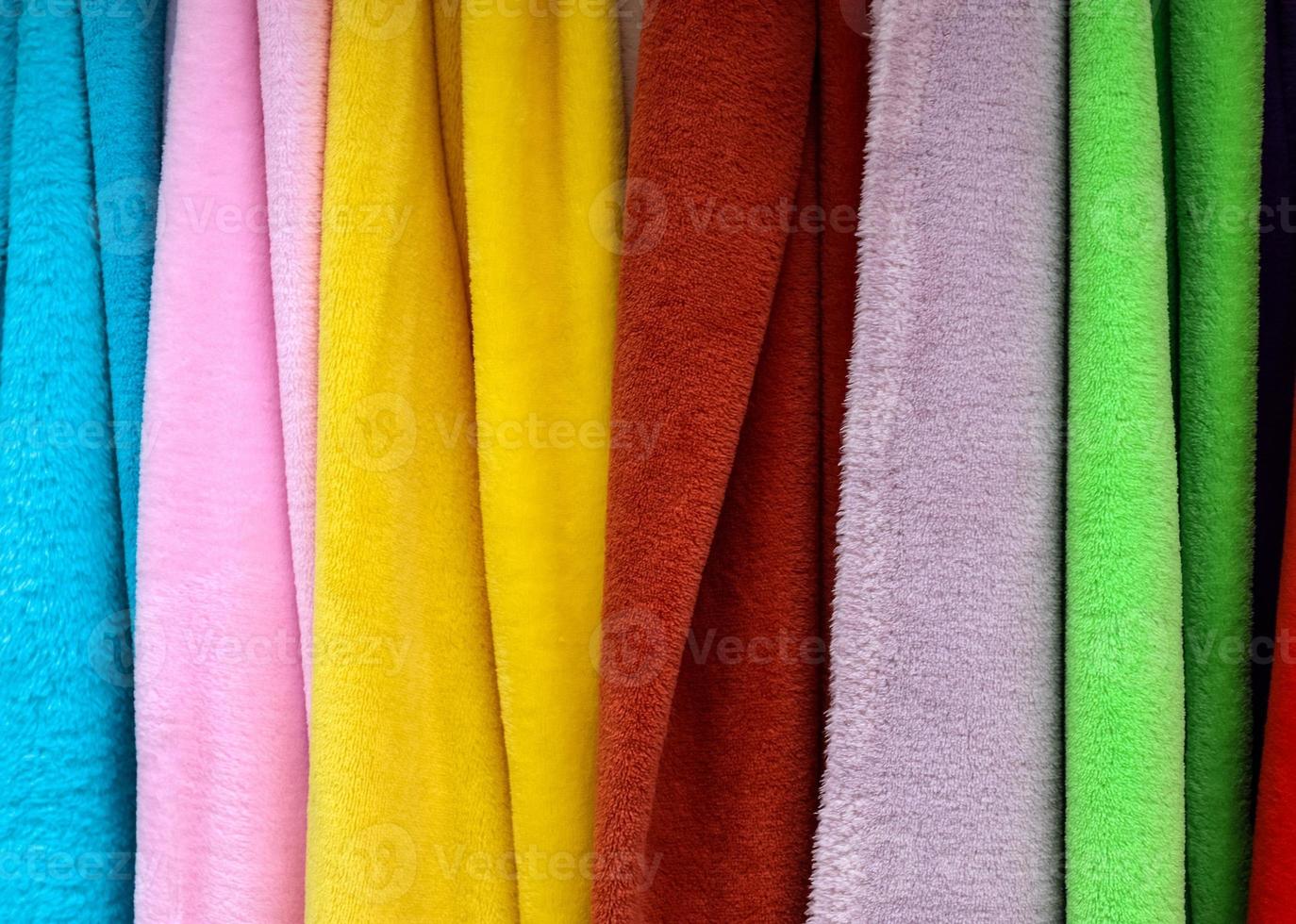 Detailed close up view on samples of cloth and fabrics in different colors found at a fabrics market photo