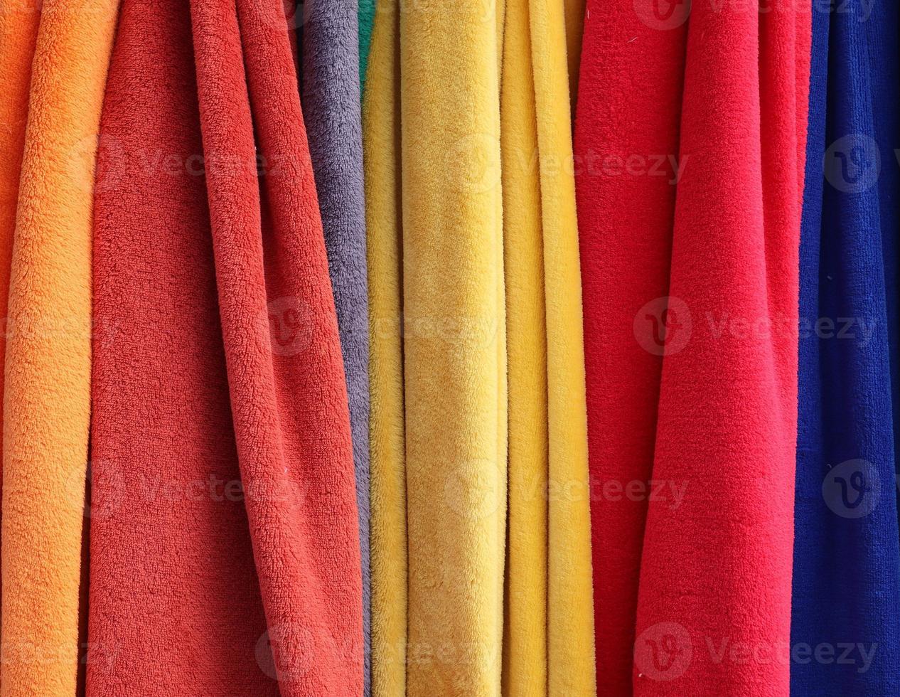Detailed close up view on samples of cloth and fabrics in different colors found at a fabrics market photo