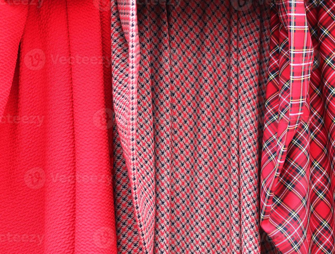 Detailed close up view on samples of cloth and fabrics in different colors found at a fabrics market photo