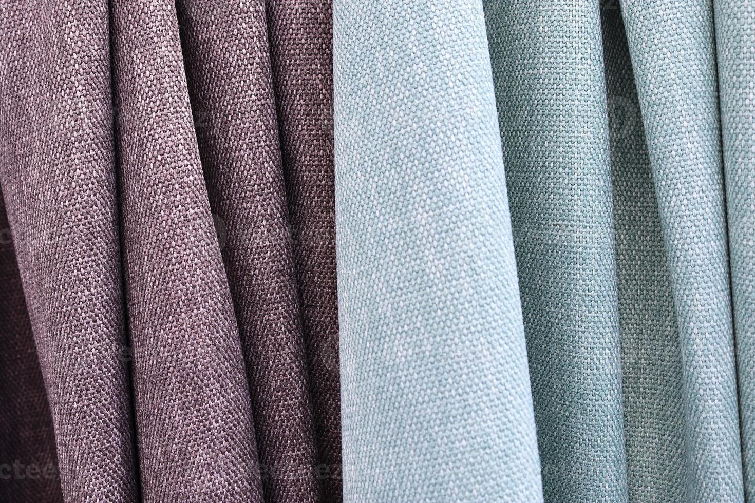 Detailed close up view on samples of cloth and fabrics in different colors found at a fabrics market photo