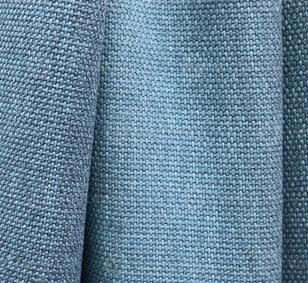 Detailed close up view on samples of cloth and fabrics in different colors found at a fabrics market photo