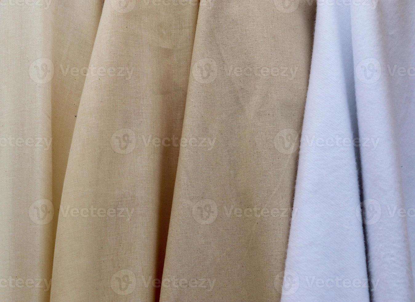 Detailed close up view on samples of cloth and fabrics in different colors found at a fabrics market photo